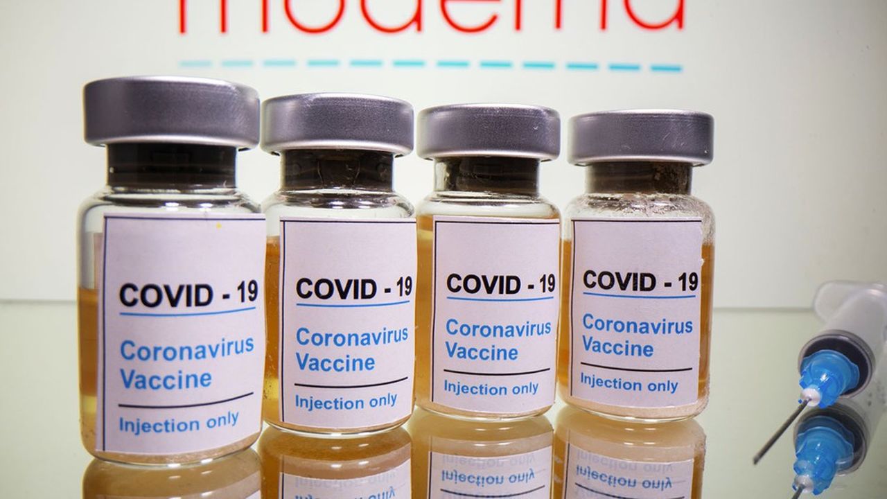 FILE PHOTO: Vials with a sticker reading, "COVID-19 / Coronavirus vaccine / Injection only" and a medical syringe are seen in front of a displayed Moderna logo in this illustration taken October 31, 2020. REUTERS/Dado Ruvic/Illustration/File Photo